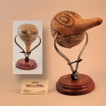 Gourd with 2 faces suspended in calipers